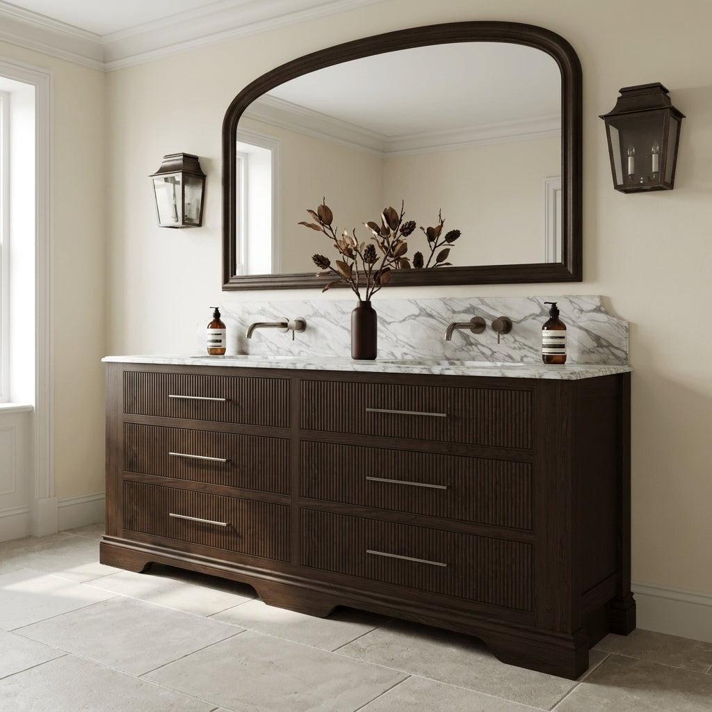 Mockridge Design Kingsbridge 1900mm floor-standing double vanity in Espresso stained oak with near-black depth and visible grain figuring and reeded drawer fronts, dramatic shaped Calacatta marble backsplash, twin undermount basins and twin deep antiqued bronze wall-mounted mixer taps, styled in a deluxe grand traditional English principal bathroom with Farrow and Ball Pointing painted walls and honed Jura limestone floor